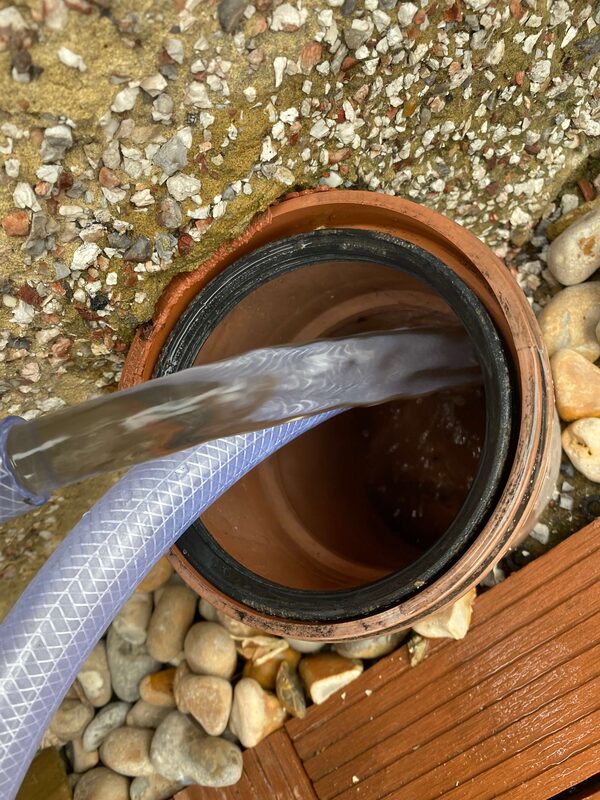 Clean clear water at the end of power flush — job complete